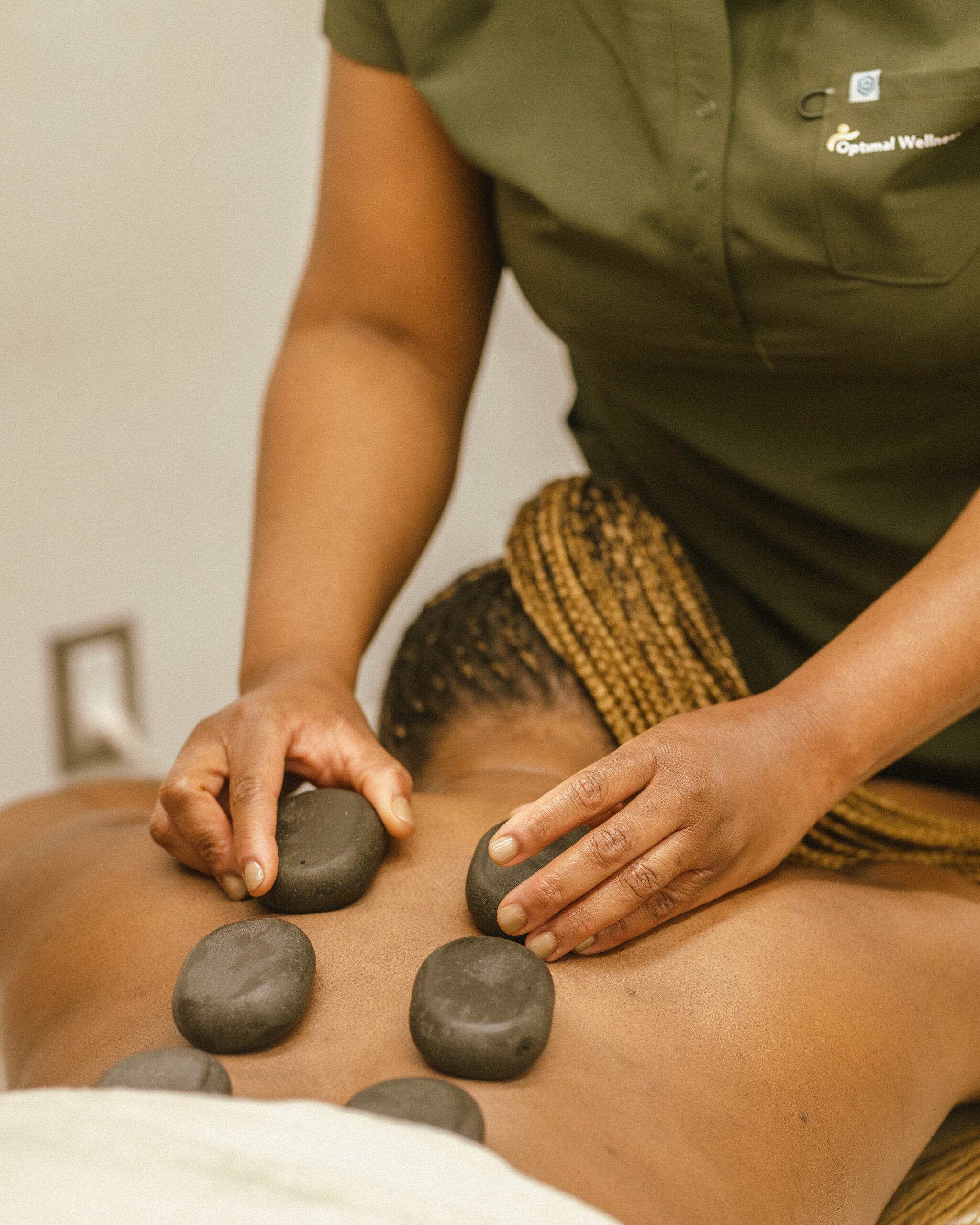 Hot stone massage treatment at Optimal Wellness Centre near Balzac and Airdrie